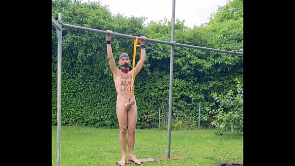 naked pathetic slave in penis cage during outdoor party tied up at his testicles entertain the guests in the rain